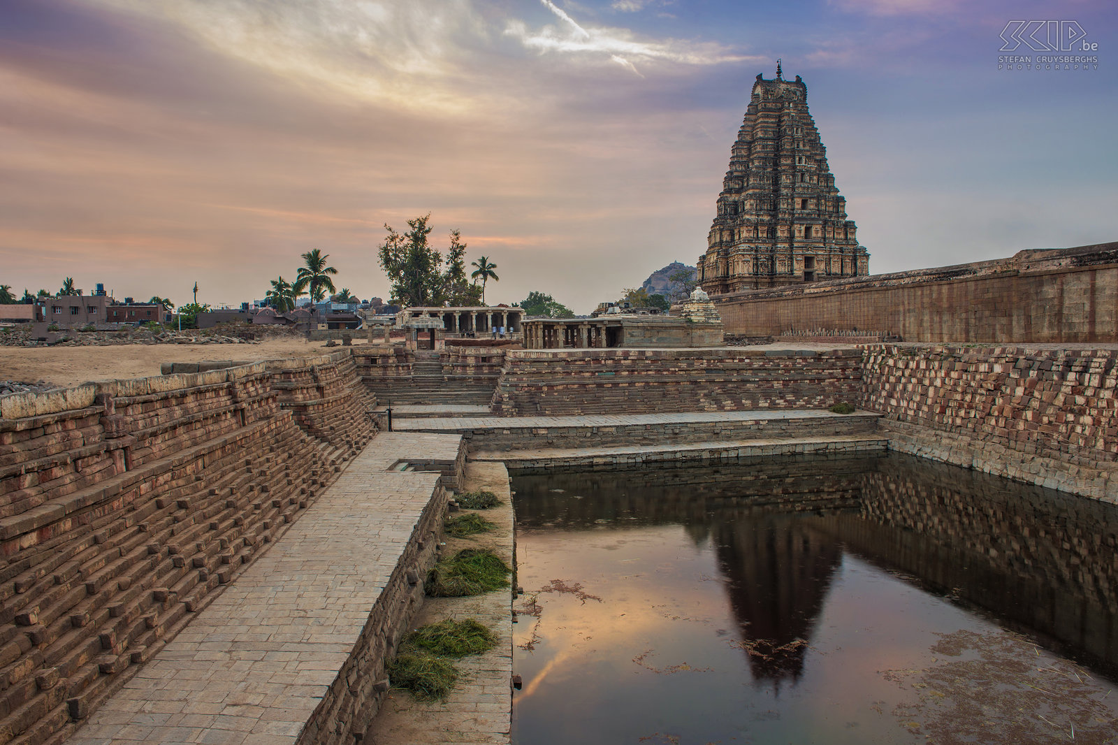 Hampi - Virupaksha temple Sunrise at the northern side of the Virupaksha temple in Hampi. The wonderful ancient city of Hampi is located in the state of Karnataka in southern India. In the 13th to 17th century it was the capital city of the Vijayanagara empire but it is believed that this temple has been built in the 7th century AD. This impressive temple is still a pilgrimage centre for the worshipers of lord Shiva. The eastern tower, called Gopura, is 49m high and has 9 stories. Stefan Cruysberghs